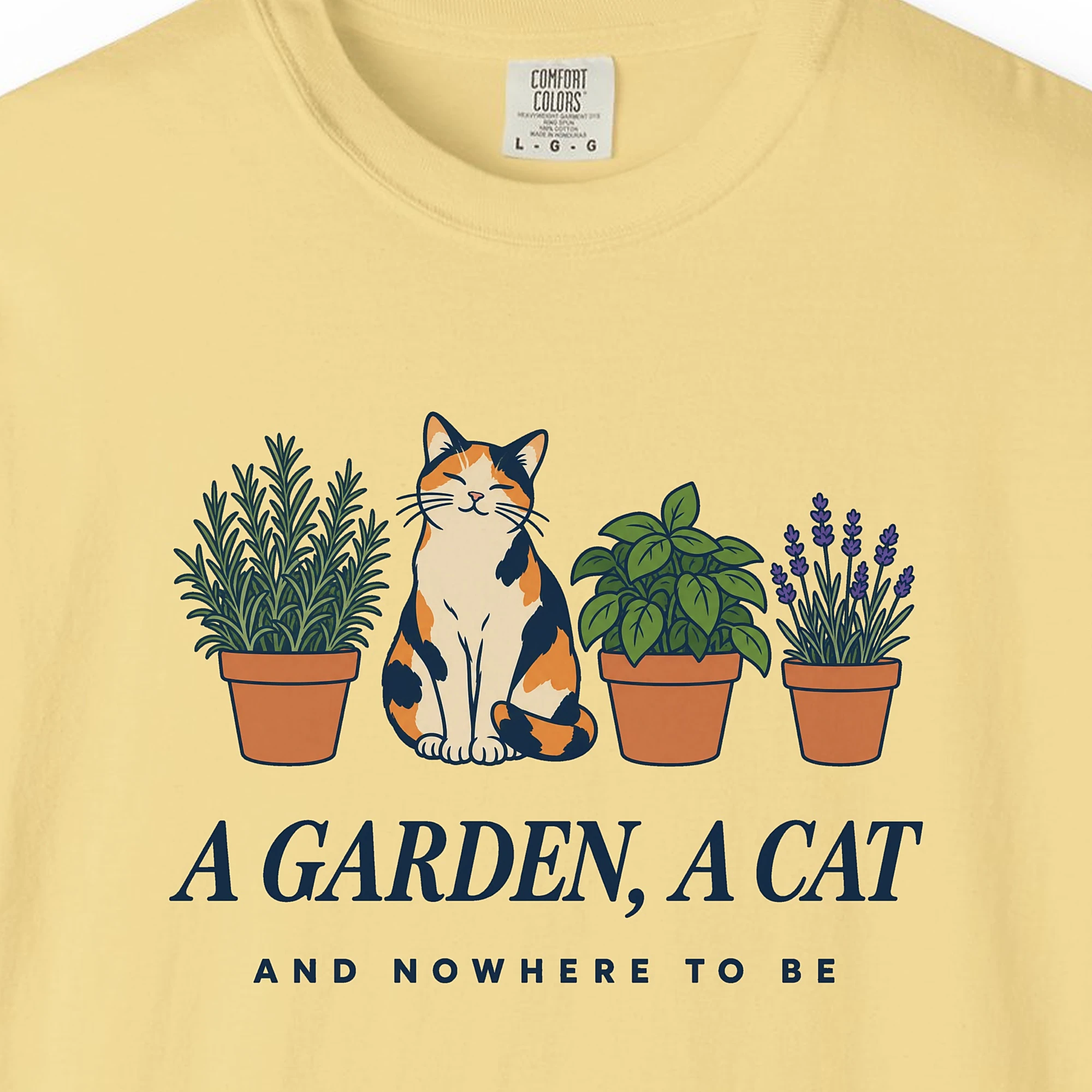 Close-up of the A Garden a Cat print on a Butter Comfort Colors 1717 tee