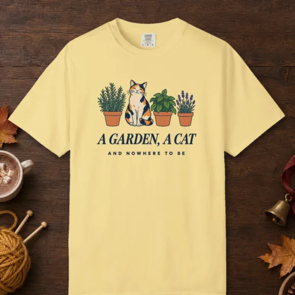 a-garden-a-cat-tee-butter-front A Garden a Cat design on a Butter Comfort Colors 1717 tee, laid flat