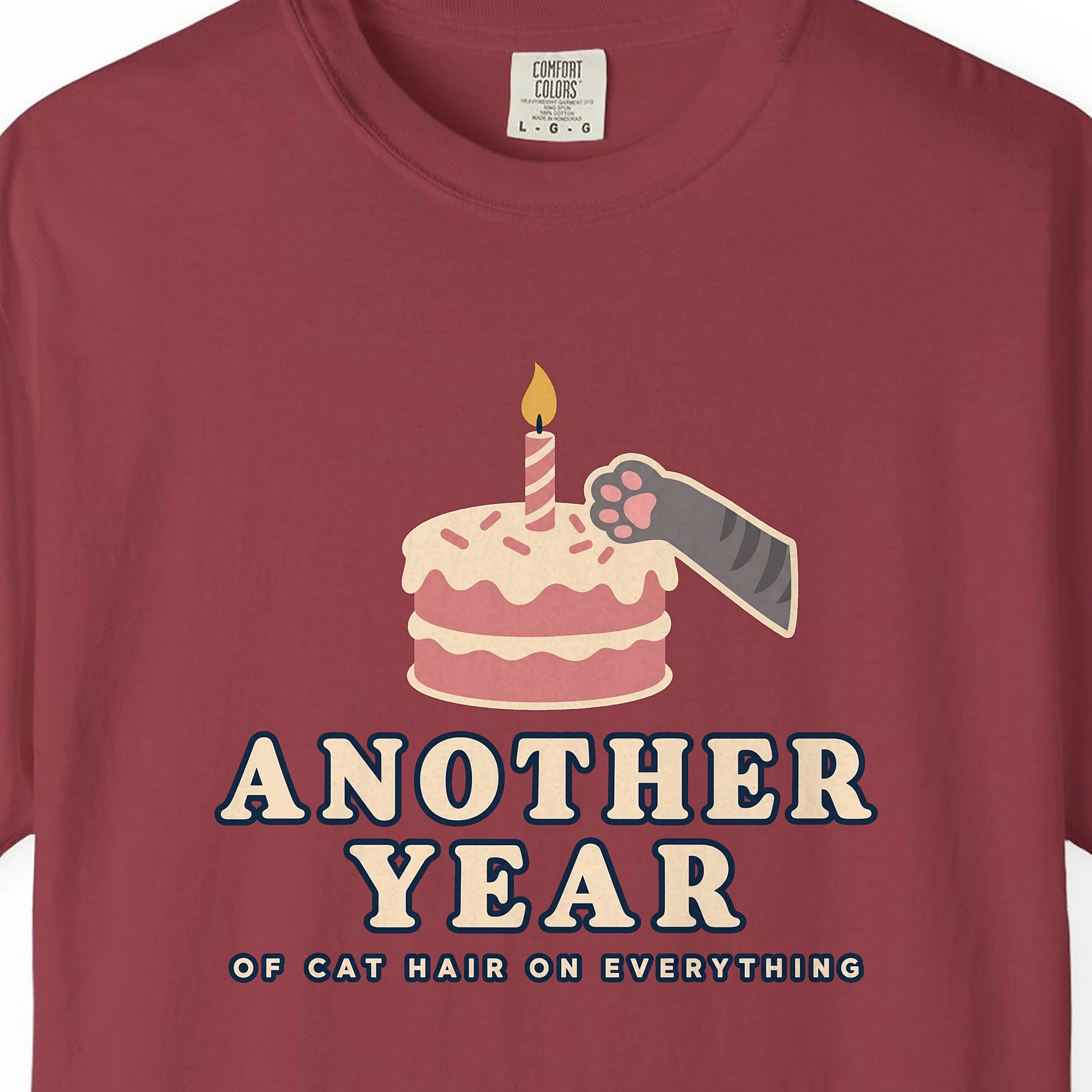 Close-up of the Another Year of Cat Hair print on a Chili Comfort Colors 1717 tee