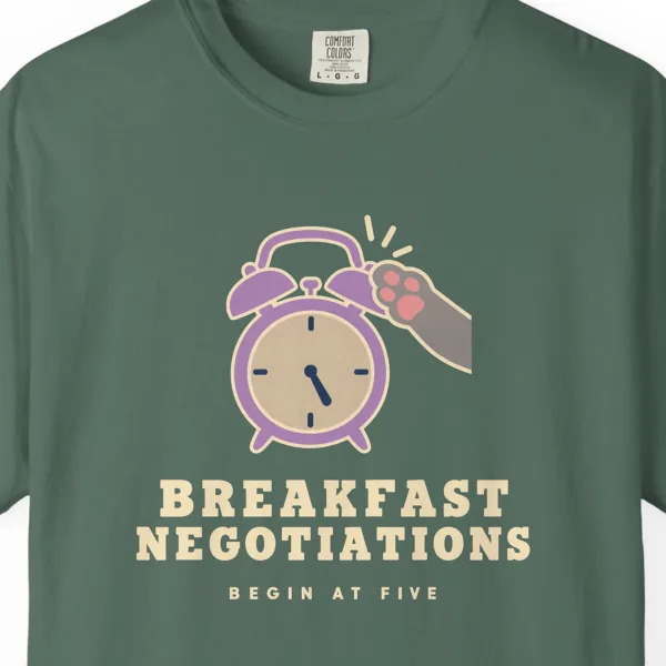 Close-up of the Breakfast Negotiations print on a Blue Spruce Comfort Colors 1717 tee