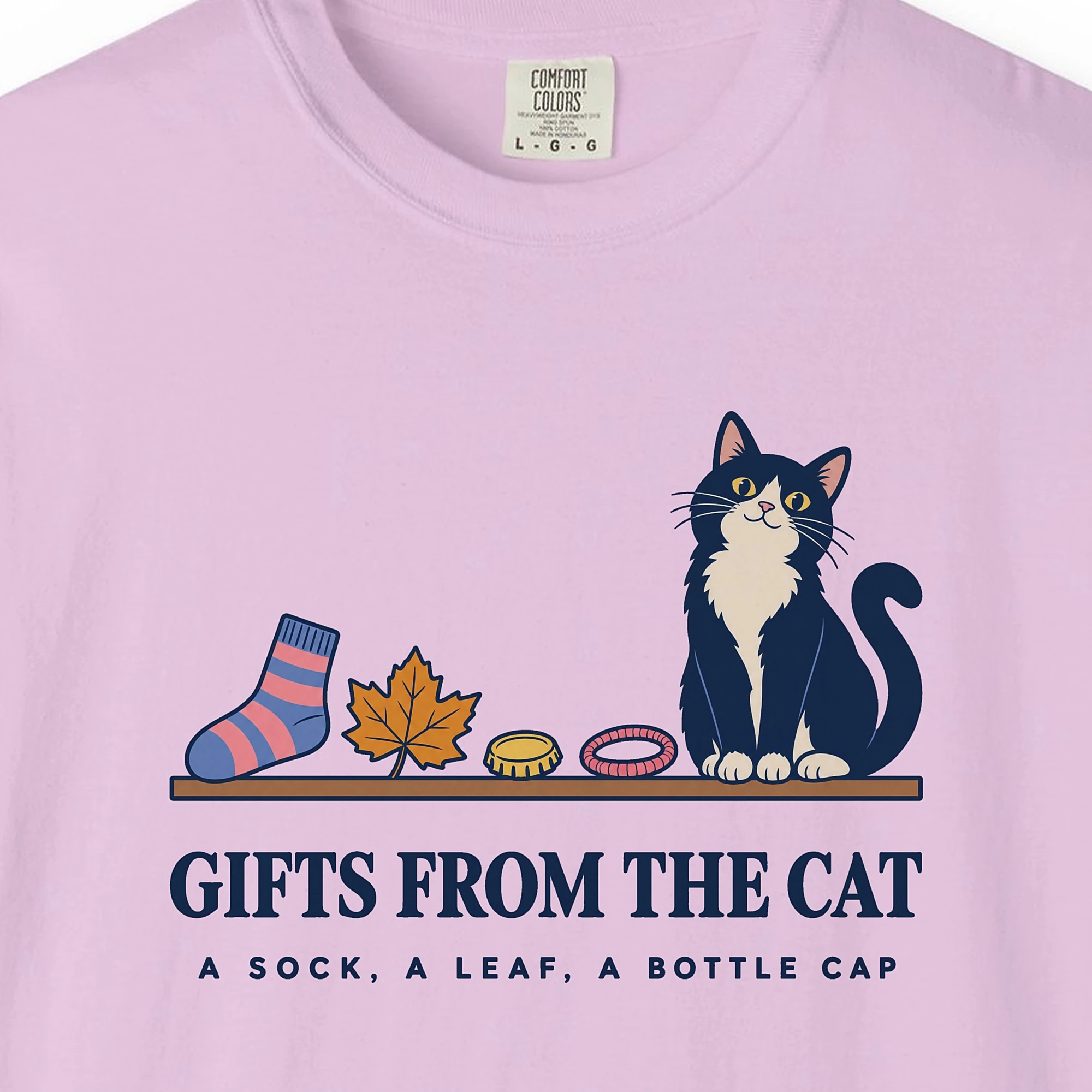 Close-up of the Gifts From the Cat print on an Orchid Comfort Colors 1717 tee