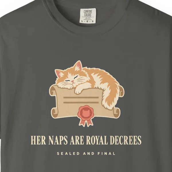 Close-up of the Her Naps Are Royal Decrees print on a Pepper Comfort Colors 1717 tee