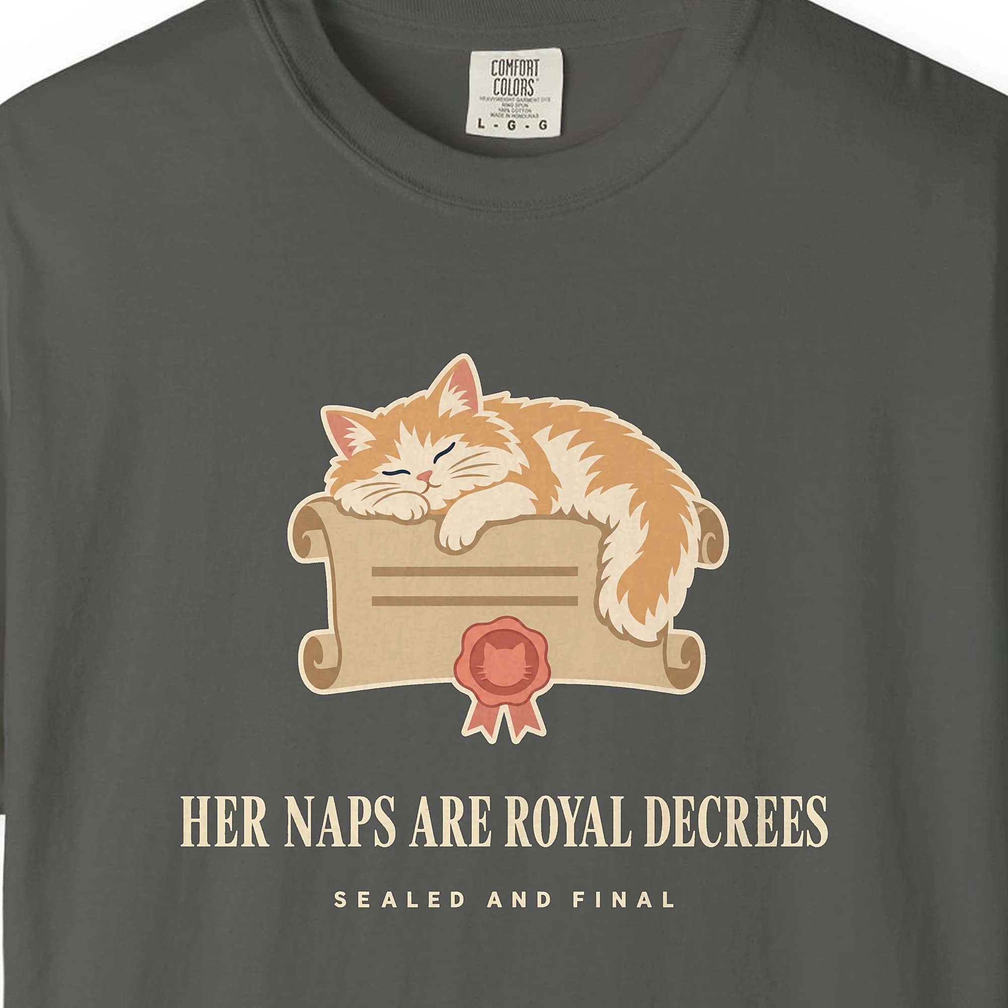Close-up of the Her Naps Are Royal Decrees print on a Pepper Comfort Colors 1717 tee