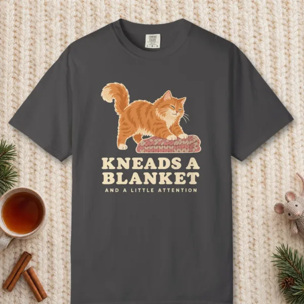 kneads-a-blanket-tee-graphite-front Kneads a Blanket design on a Graphite Comfort Colors 1717 tee, laid flat