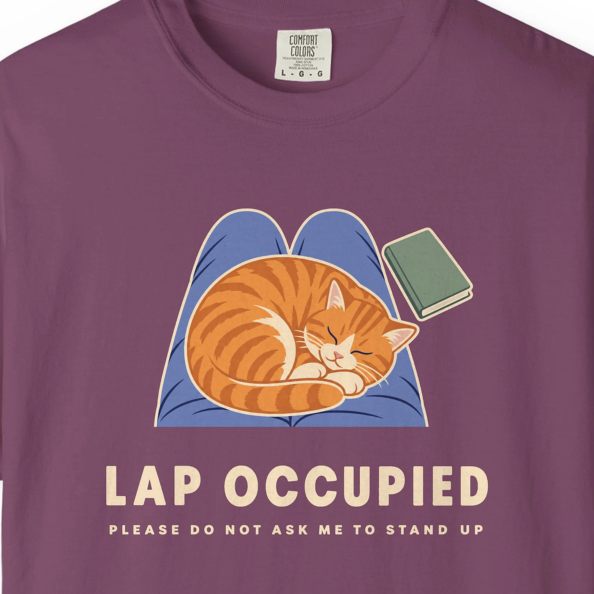Close-up of the Lap Occupied print on a Berry Comfort Colors 1717 tee