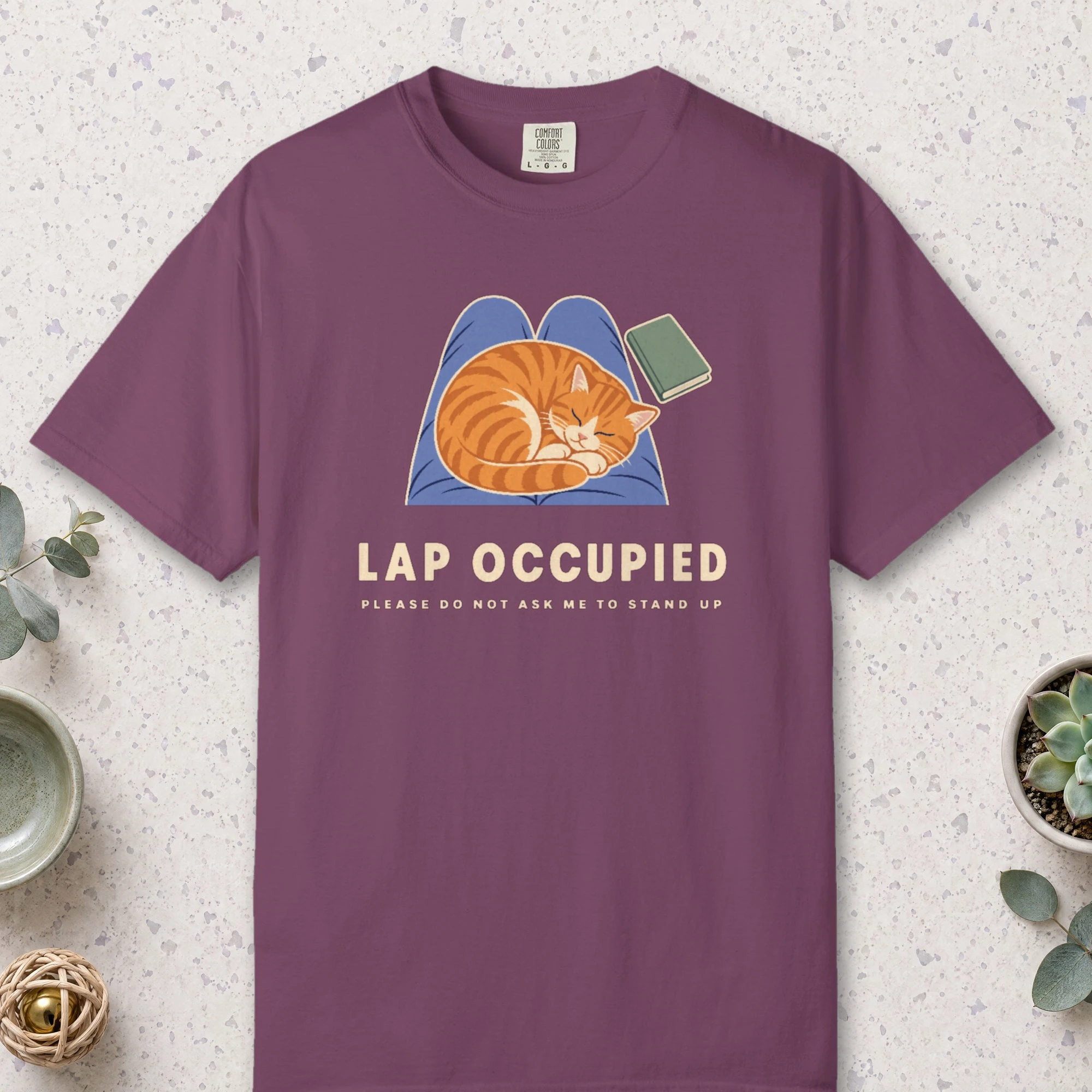 Lap Occupied design on a Berry Comfort Colors 1717 tee, laid flat