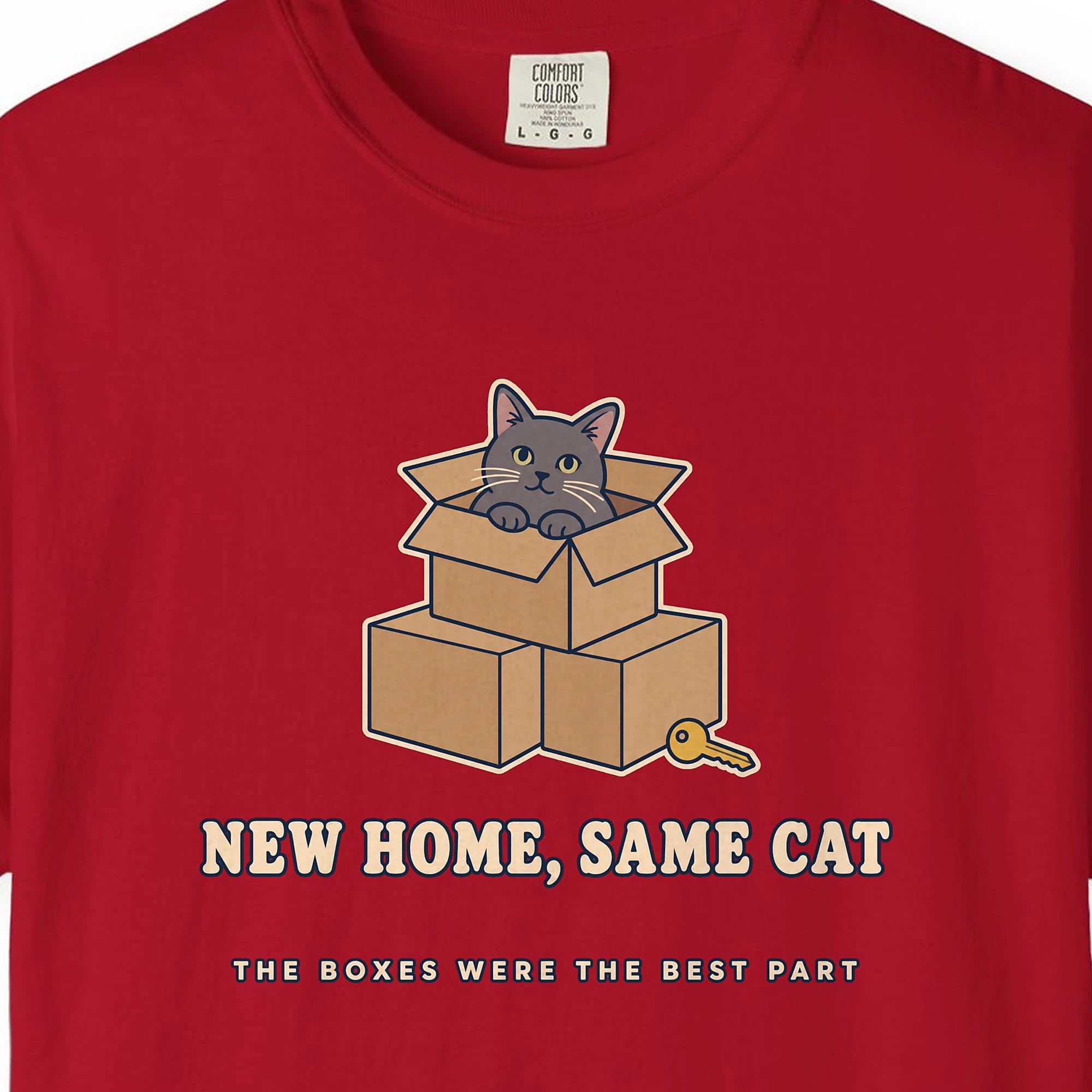 Close-up of the New Home, Same Cat print on a Red Comfort Colors 1717 tee