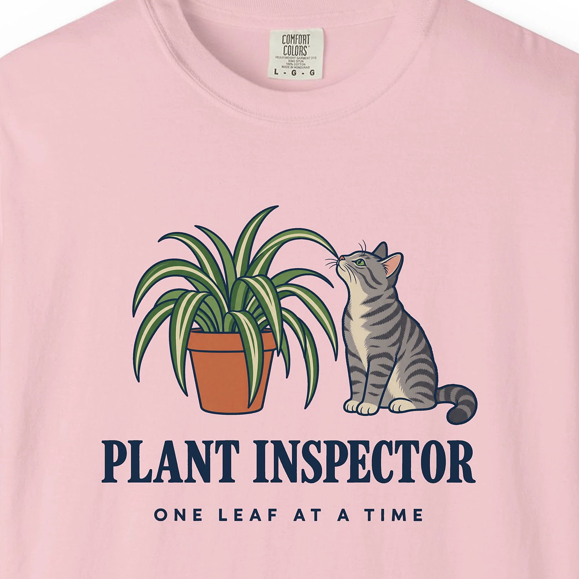 Close-up of the Plant Inspector print on a Blossom Comfort Colors 1717 tee