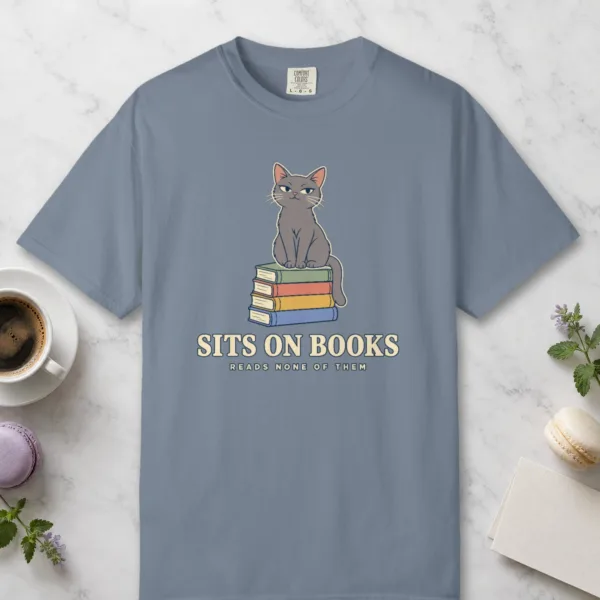 Sits on Books design on a Blue Jean Comfort Colors 1717 tee, laid flat