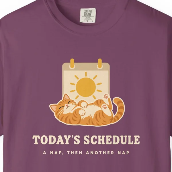 Close-up of the Today's Schedule print on a Berry Comfort Colors 1717 tee