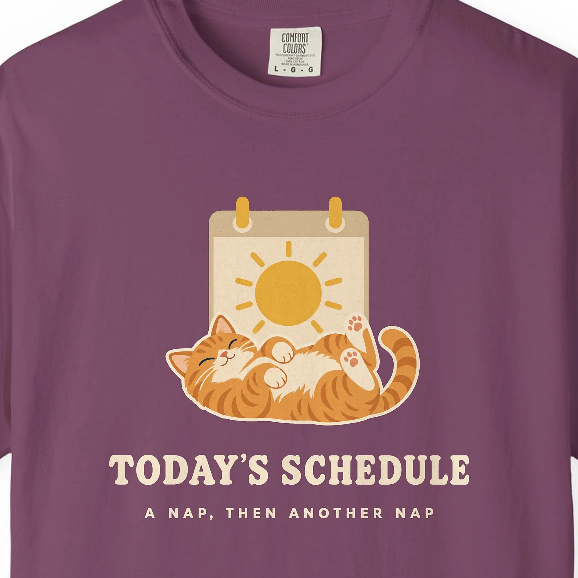 Close-up of the Today's Schedule print on a Berry Comfort Colors 1717 tee