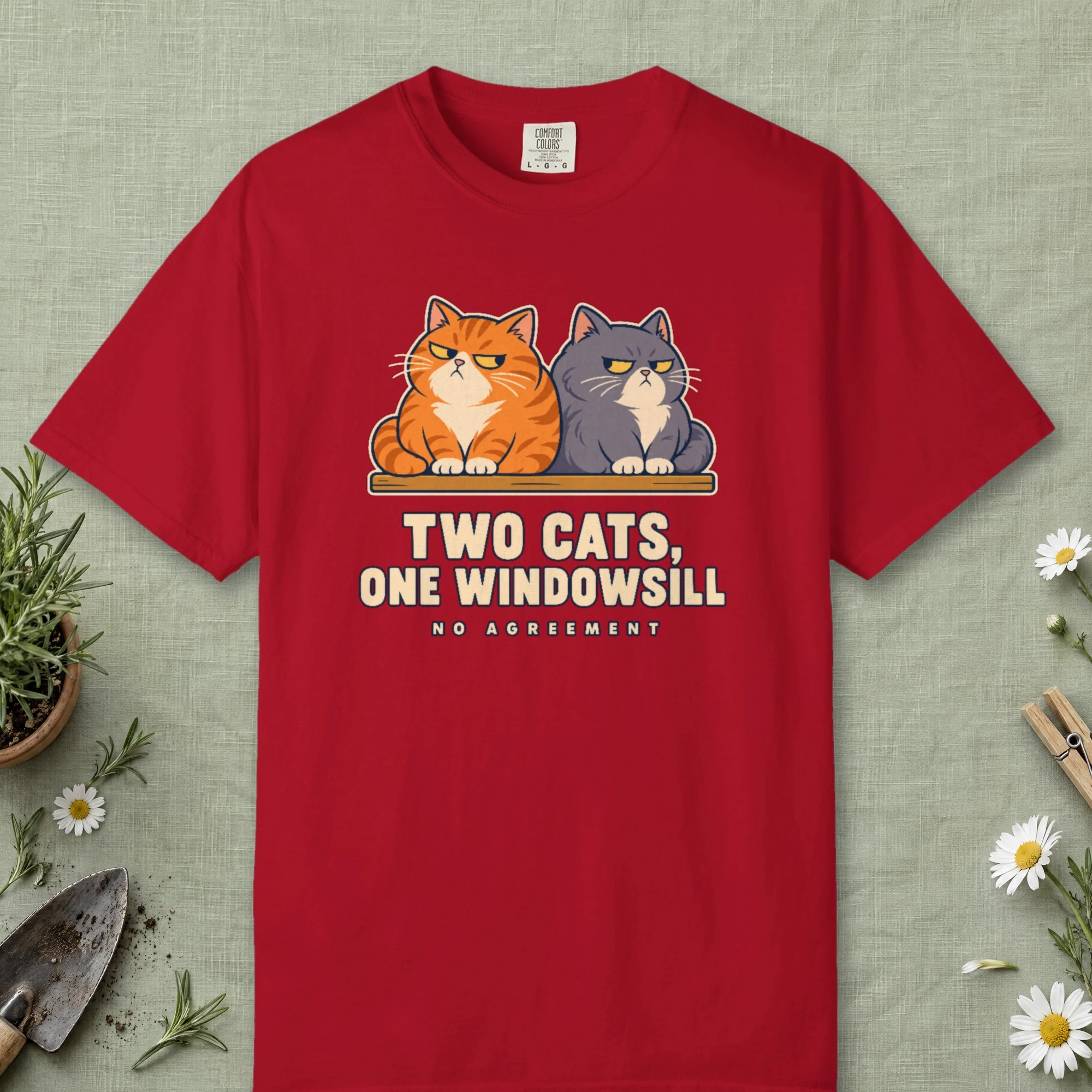 Two Cats One Windowsill design on a Red Comfort Colors 1717 tee, laid flat
